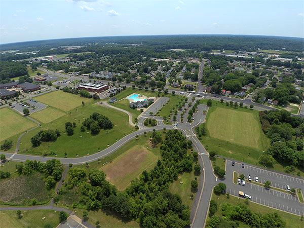 Virginia Custom Built Homes: Aerial View of Dixon Park with Roads, Trees, Parking Lot, and Swimming Pool
